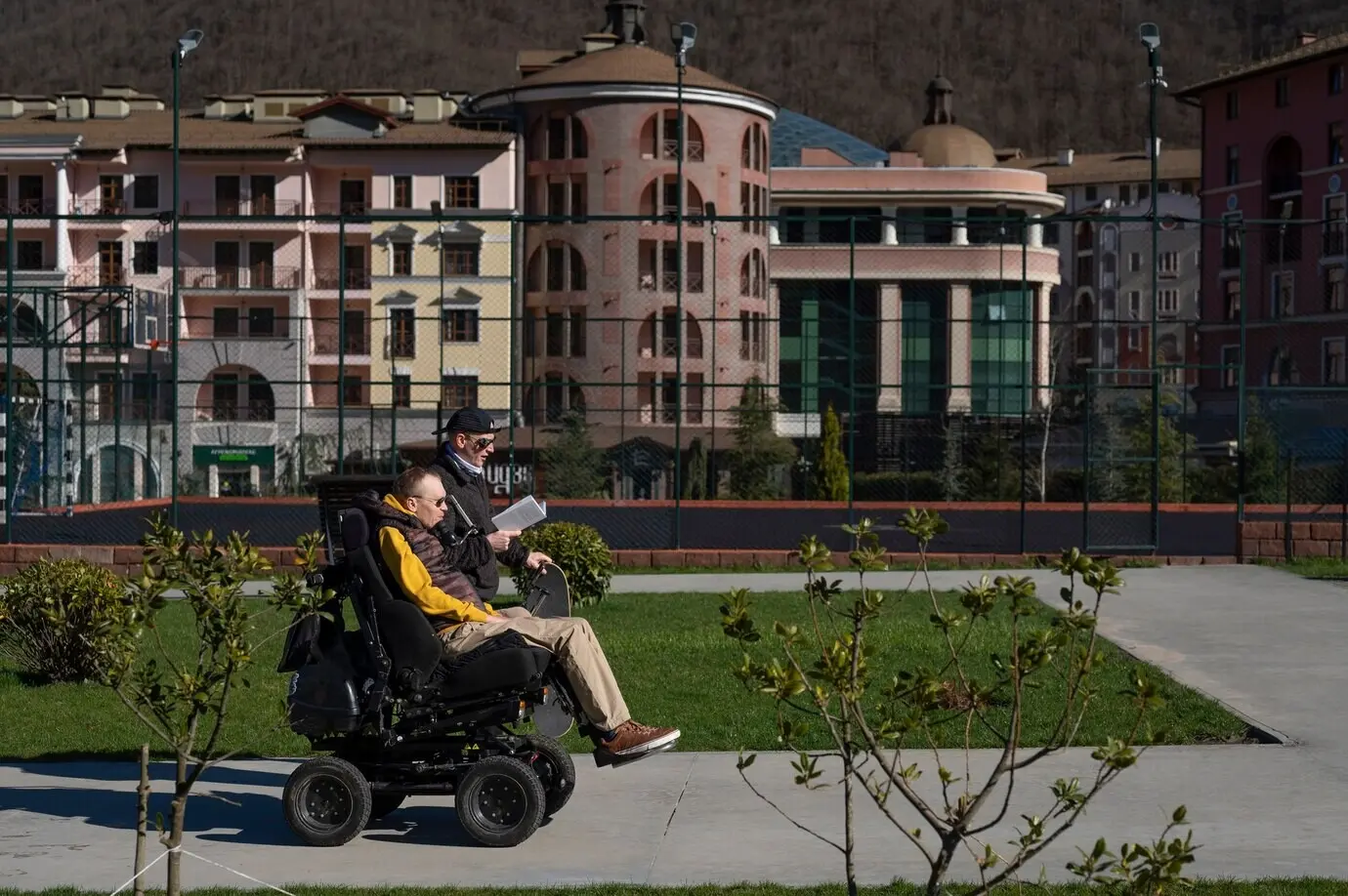 A medium shot of friends reading together outside.