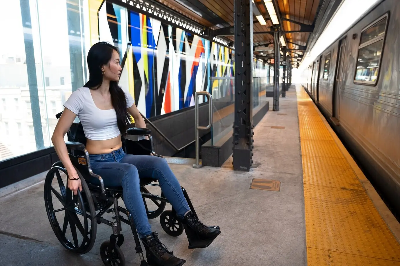 Full-length shot of a disabled woman traveling by train.